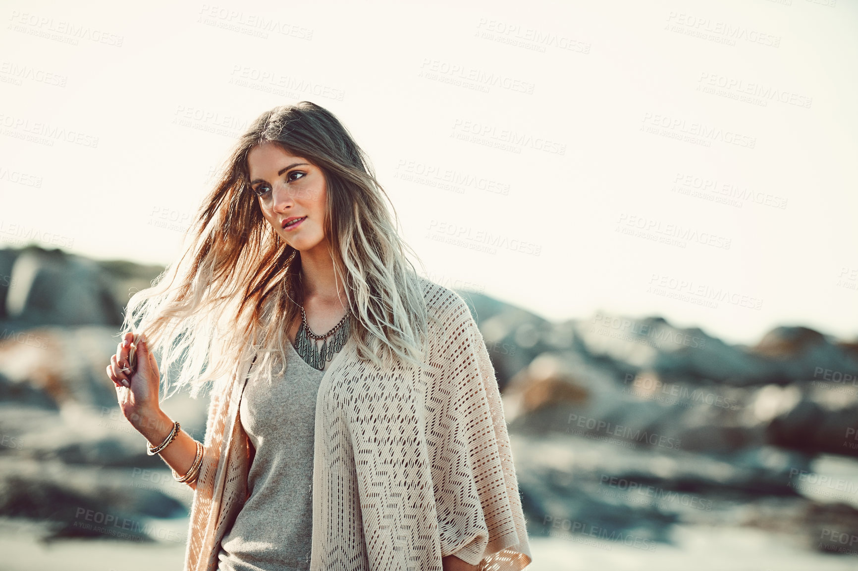 Buy stock photo Shot of an attractive young woman spending a day at the beach