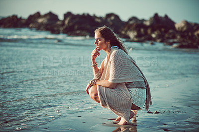 Buy stock photo Shot of an attractive young woman spending a day at the beach