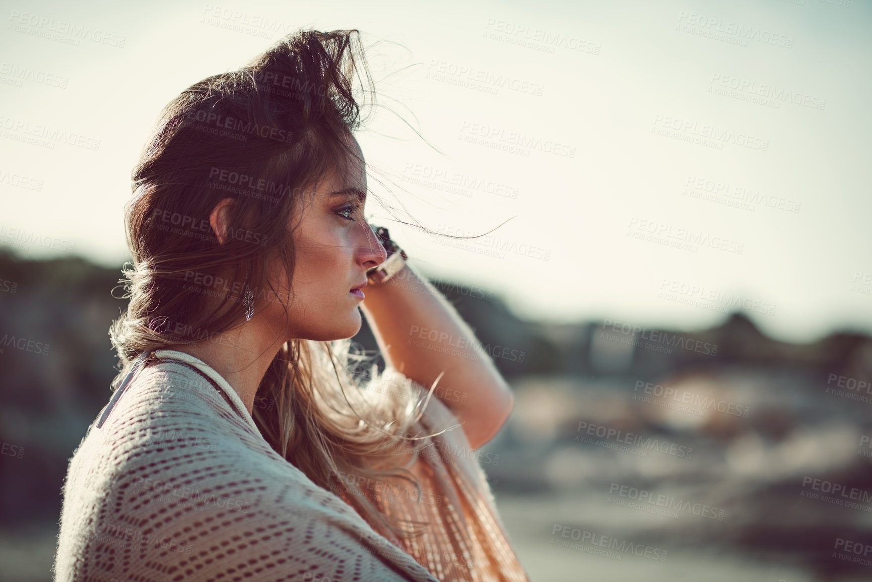 Buy stock photo Shot of an attractive young woman spending a day at the beach