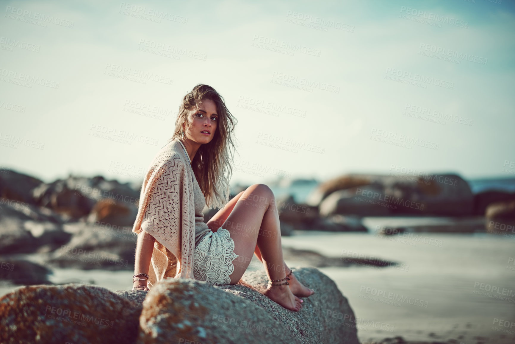 Buy stock photo Shot of an attractive young woman spending a day at the beach