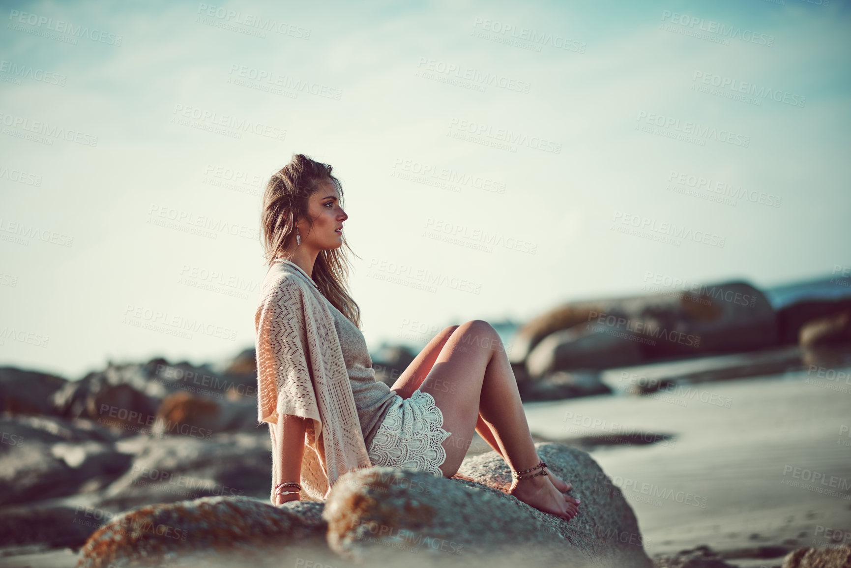 Buy stock photo Shot of an attractive young woman spending a day at the beach