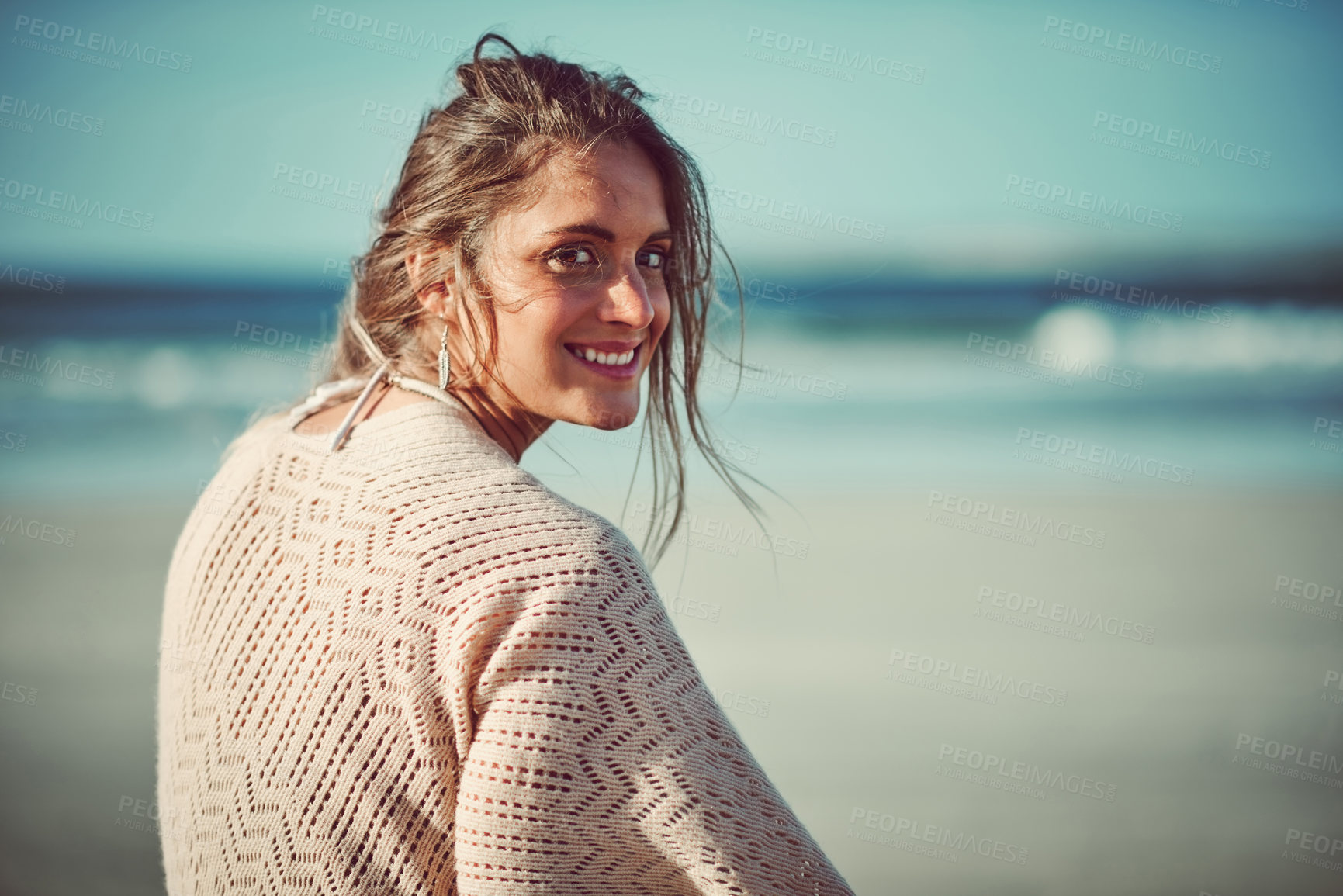 Buy stock photo Shot of an attractive young woman spending a day at the beach