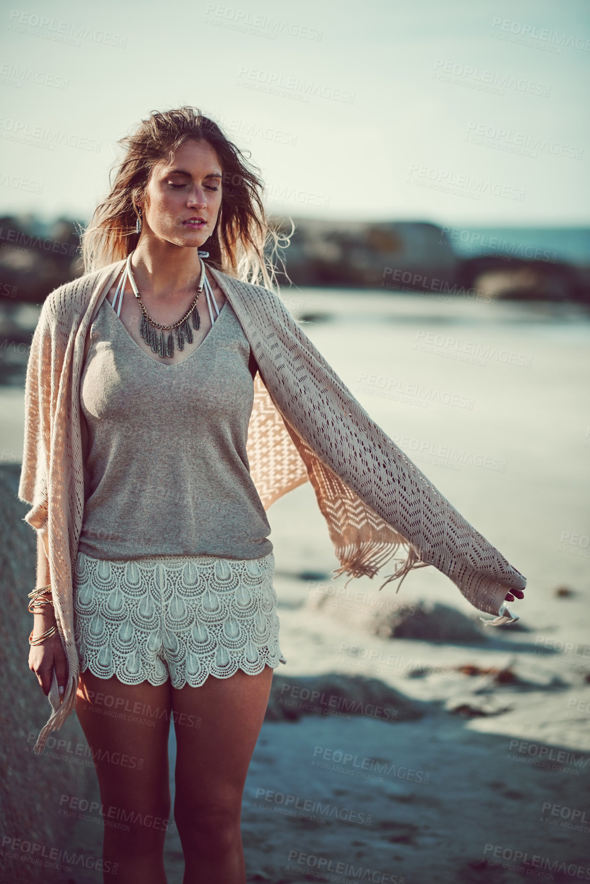 Buy stock photo Shot of an attractive young woman spending a day at the beach