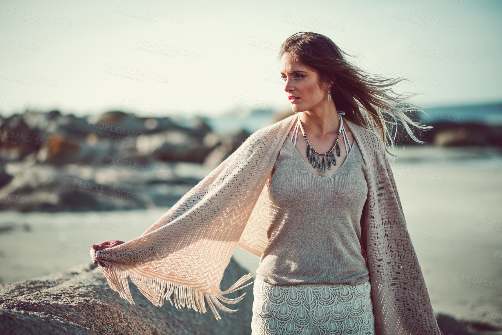 Buy stock photo Shot of an attractive young woman spending a day at the beach