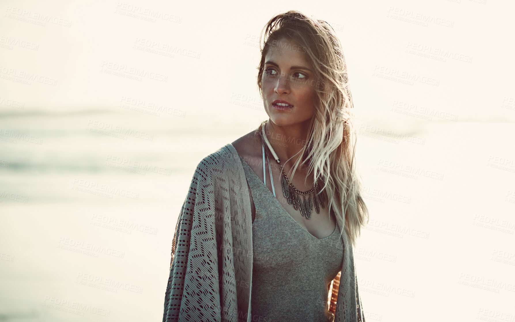 Buy stock photo Shot of an attractive young woman spending a day at the beach