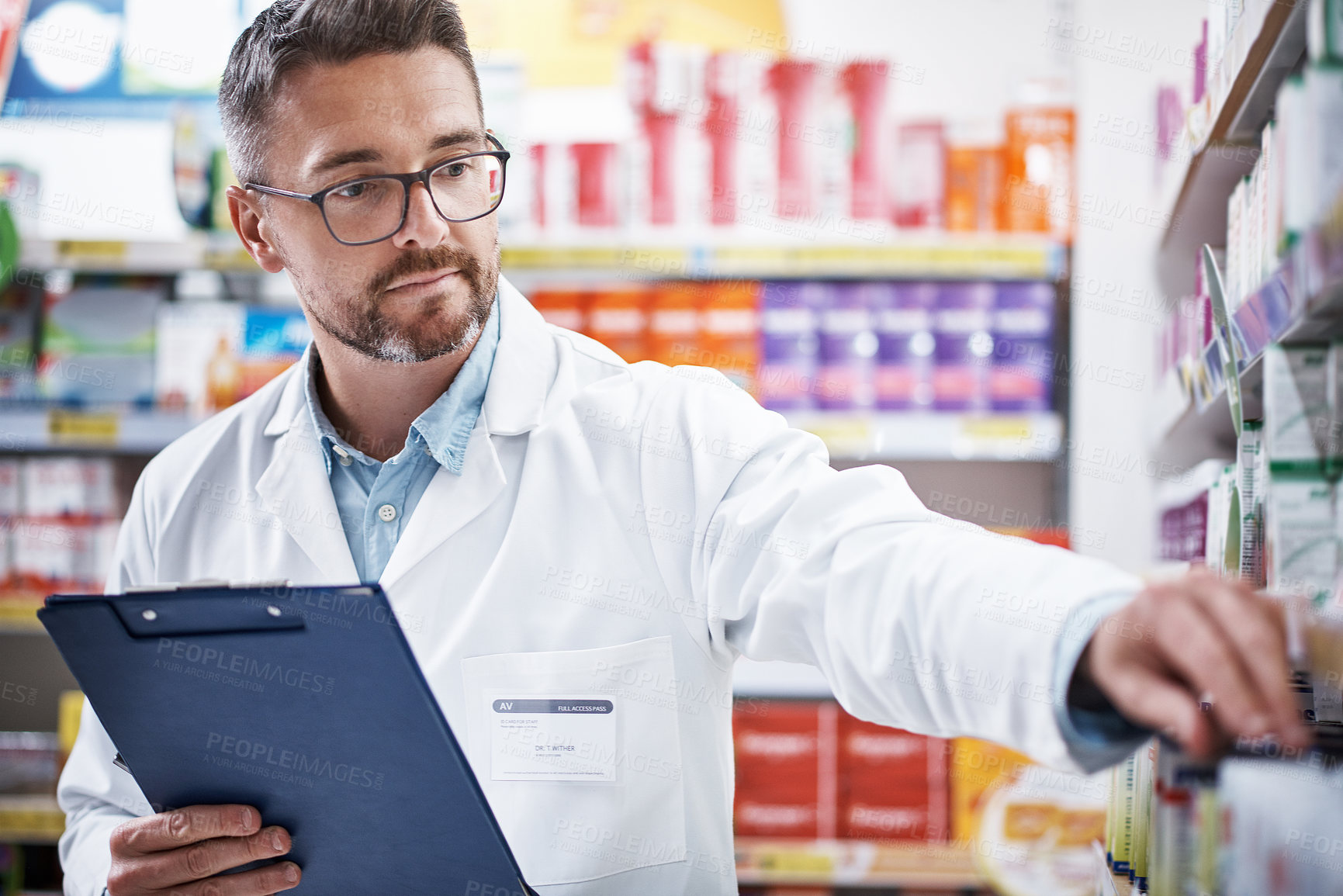 Buy stock photo Shot of a mature pharmacist doing inventory in a pharmacy