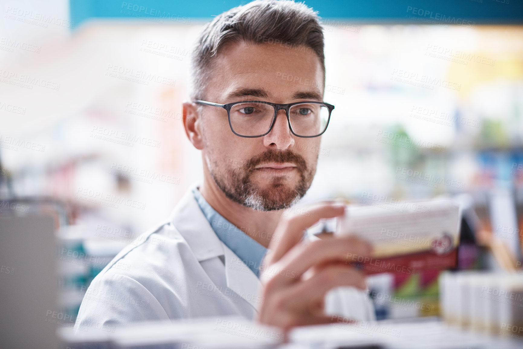 Buy stock photo Shot of a mature pharmacist doing inventory in a pharmacy