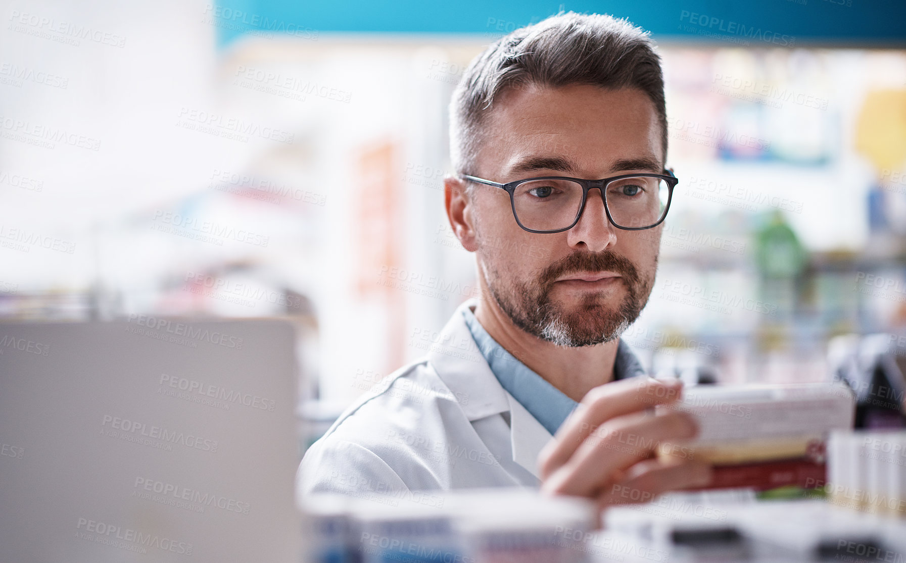 Buy stock photo Shot of a mature pharmacist doing inventory in a pharmacy