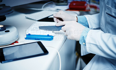 Buy stock photo Cropped shot of a pharmacist counting medication