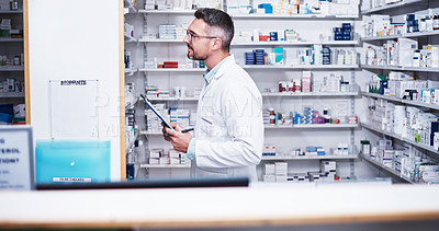 Buy stock photo Shot of a mature pharmacist doing inventory in a pharmacy