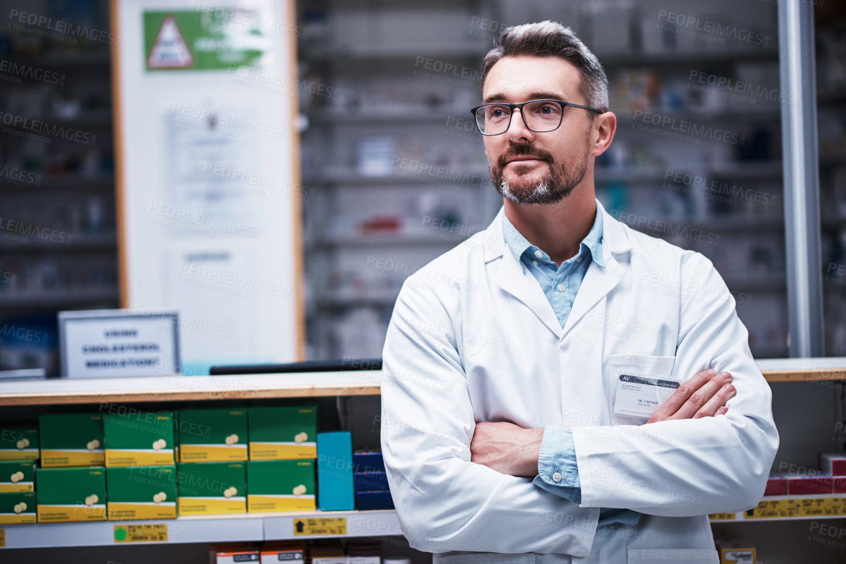 Buy stock photo Shot of a mature pharmacist working in a pharmacy