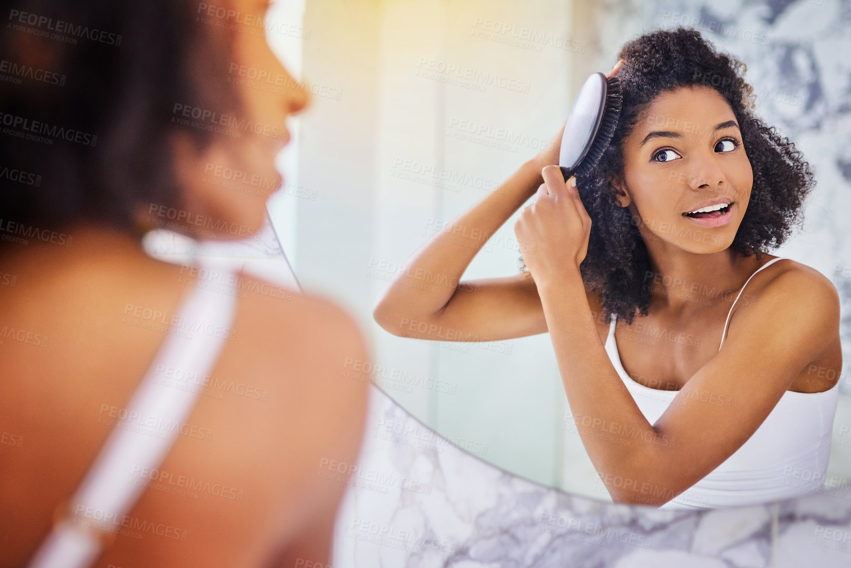 Buy stock photo Morning, hair care and black woman in reflection with brush, smile and getting ready for afro style routine in home. Grooming, conditioner and girl in bathroom mirror with healthy keratin treatment