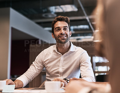Buy stock photo Shot of a young businessman having a meeting with a colleague in an office