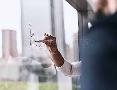 Buy stock photo Closeup shot of an unrecognizable businesswoman writing on a glass wall in an office