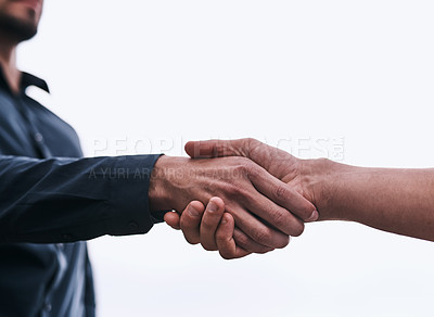 Buy stock photo Closeup shot of two unrecognizable businessmen shaking hands against a white background
