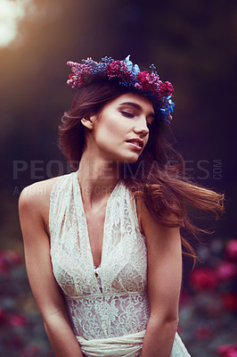 Buy stock photo Shot of a beautiful young woman wearing a floral head wreath outdoors