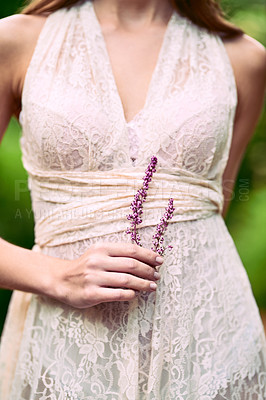 Buy stock photo Cropped shot of an unrecognizable woman holding a flower posing in nature
