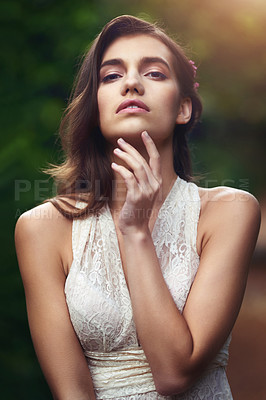 Buy stock photo Cropped shot of a beautiful young woman posing in nature
