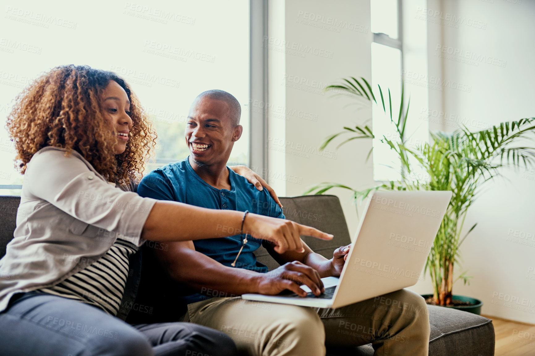 Buy stock photo Shot of a young couple using a laptop together at home