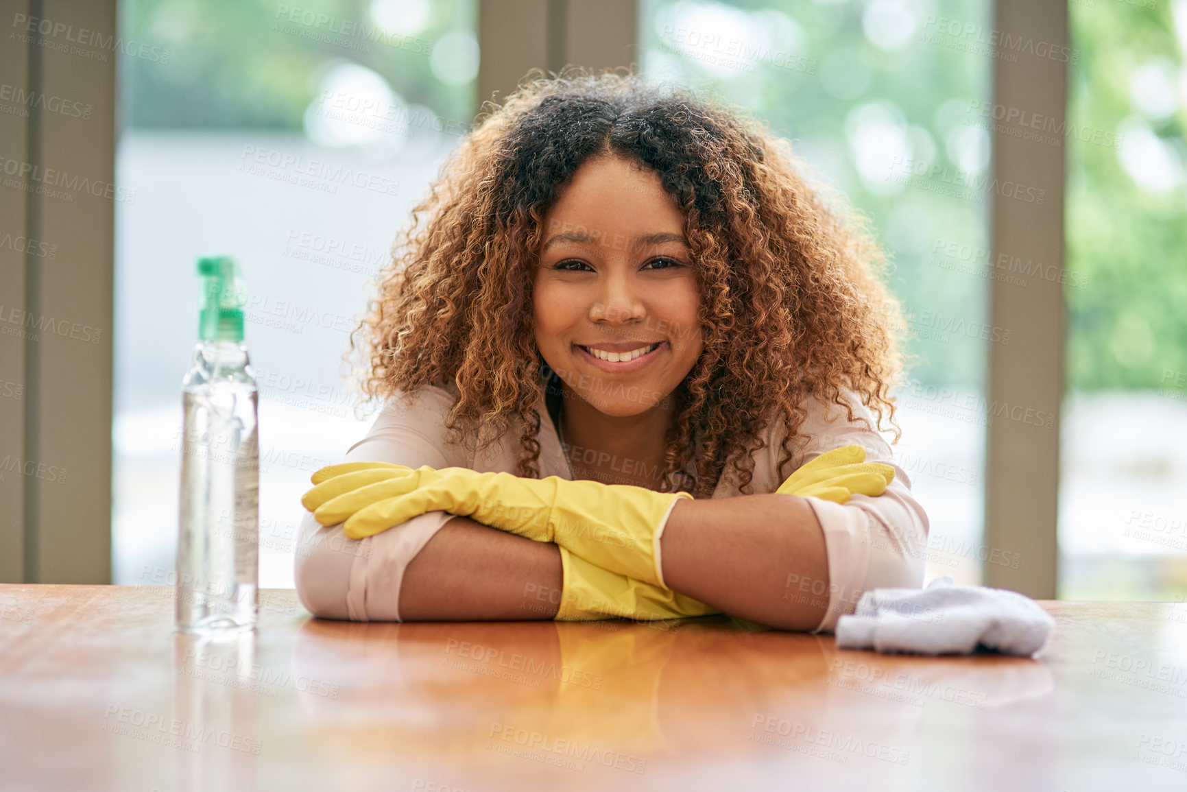 Buy stock photo Woman, home and happy with cleaning spray or detergent for hygiene, sanitary and disinfection. Housekeeping, maid and portrait with chemical bottle for germs in desk with gloves for protection