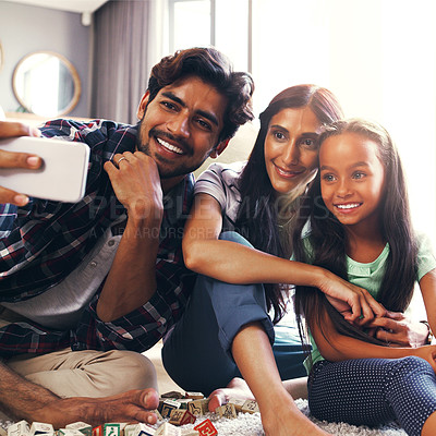 Buy stock photo Cropped shot of a young family taking a selfie at home