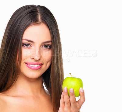 Buy stock photo Studio portrait of a beautiful young woman eating an apple against a white background