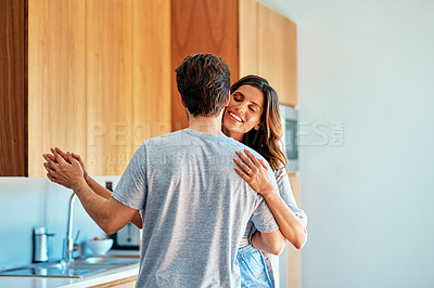 Buy stock photo Shot of an affectionate young couple dancing together at home