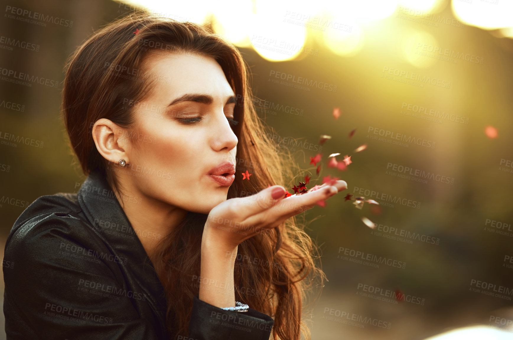 Buy stock photo Nature, freedom and woman blowing confetti on field with hope, wish or optimism in countryside. Face, beauty and female person in park with flower petals, peace and superstition in outdoor travel