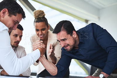 Buy stock photo Shot of two businessmen arm wrestling in an office