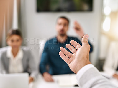 Buy stock photo Closeup shot of an unrecognizable businessman gesturing towards a colleague during a meeting in an office