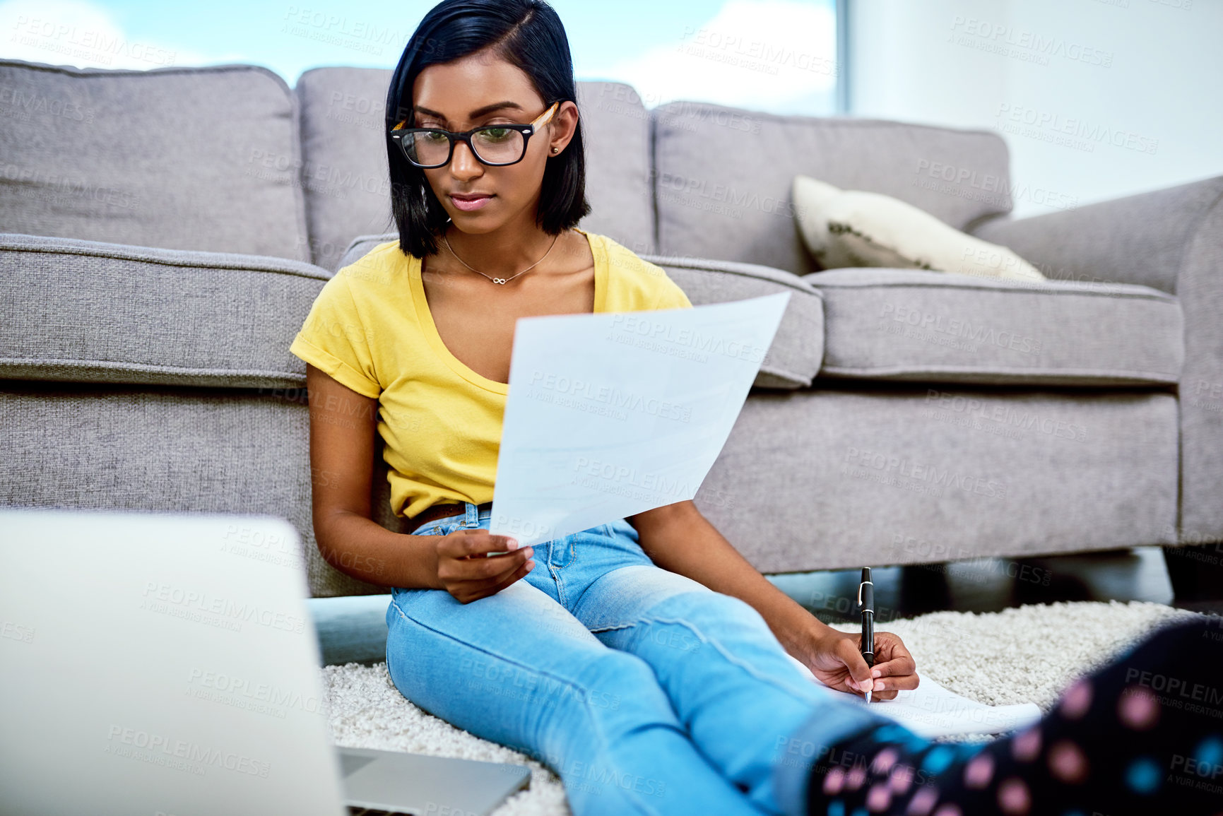 Buy stock photo Shot of a teenage girl doing schoolwork at home