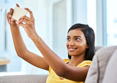 Buy stock photo Shot of a teenage girl taking a selfie at home