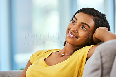 Buy stock photo Face, smile and thinking with Indian woman on sofa in living room of home for contemplation or wellness. Girl, idea and future with happy person in apartment on weekend for memories or planning