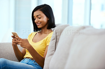 Buy stock photo Indian girl, smile and phone on sofa in home for social media scroll, internet subscription and online streaming. Gen z, happy person and smartphone on couch for text message, dating site and relax