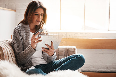 Buy stock photo Bank, tablet and credit card with a woman online shopping on a sofa in the living room of her home. Ecommerce, finance payment and fintech banking with a young female online customer in her house