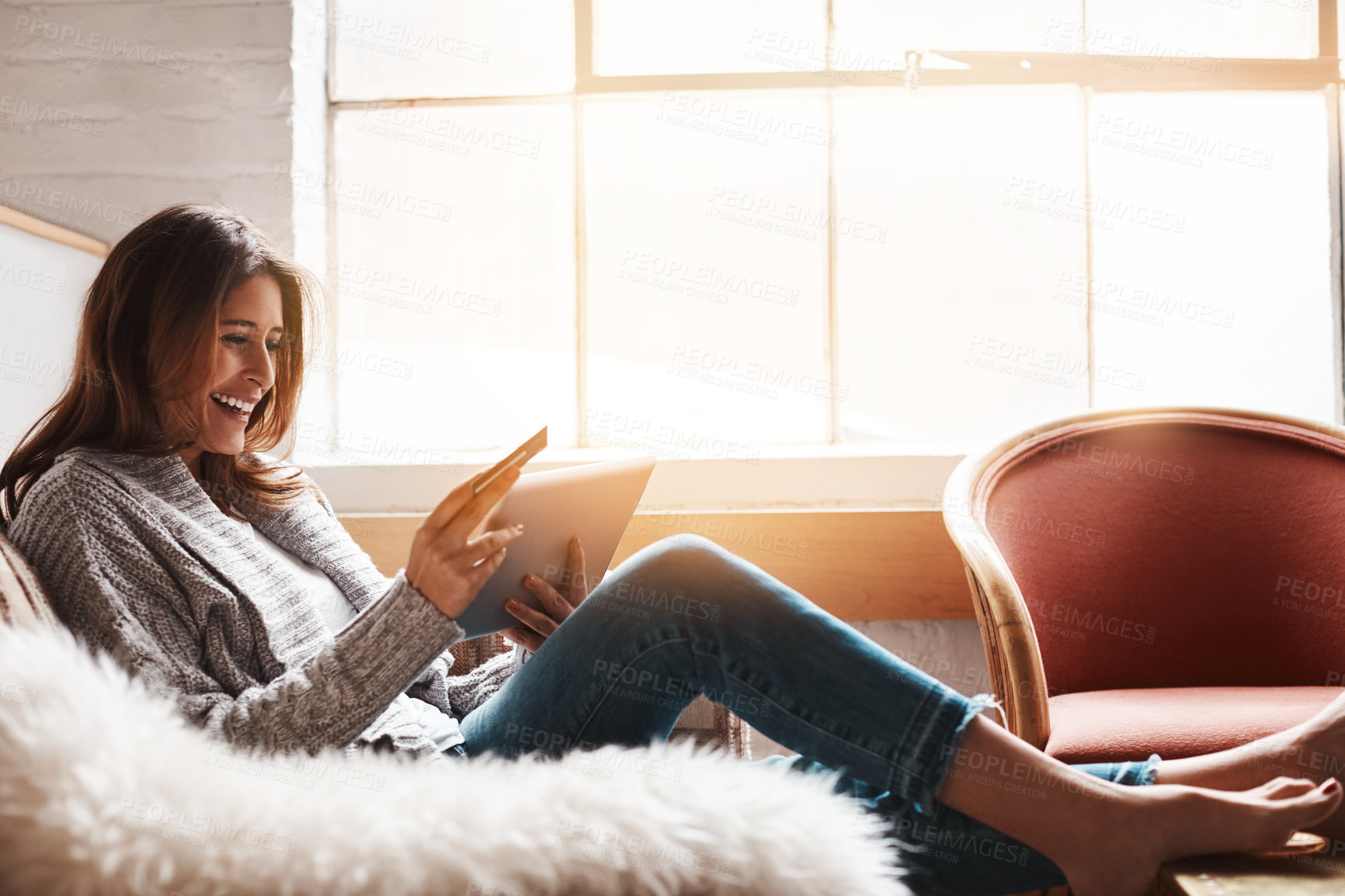 Buy stock photo Smile, tablet and credit card with an ecommerce woman on a sofa in the living room of her home. Online shopping, finance and fintech banking with a happy young female online customer in her house