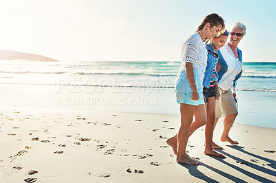 Buy stock photo Full length shot of a senior woman spending the day at the beach with her daughter and granddaughter