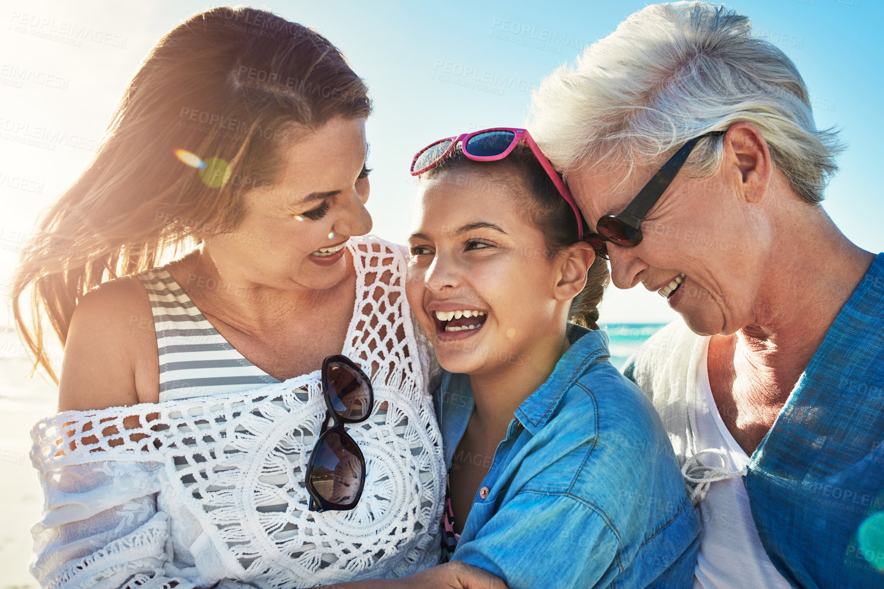 Buy stock photo Cropped shot of a senior woman spending the day at the beach with her daughter and granddaughter