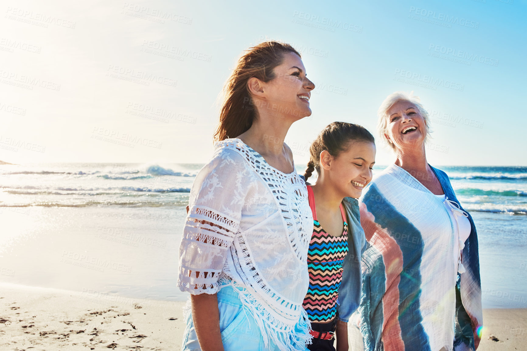 Buy stock photo Cropped shot of a senior woman spending the day at the beach with her daughter and granddaughter