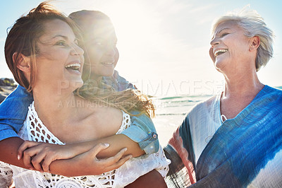 Buy stock photo Cropped shot of a senior woman spending the day at the beach with her daughter and granddaughter