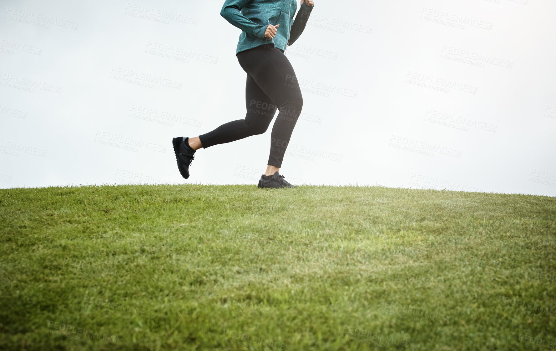 Buy stock photo Cropped shot of a woman going for a run in nature