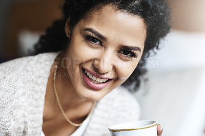 Buy stock photo Portrait of an attractive young woman relaxing at home with a cup of coffee