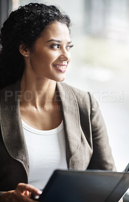 Buy stock photo Shot of a young businesswoman reading through a business folder in an office