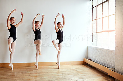 Buy stock photo Shot of a group of young girls practicing ballet together in a dance studio