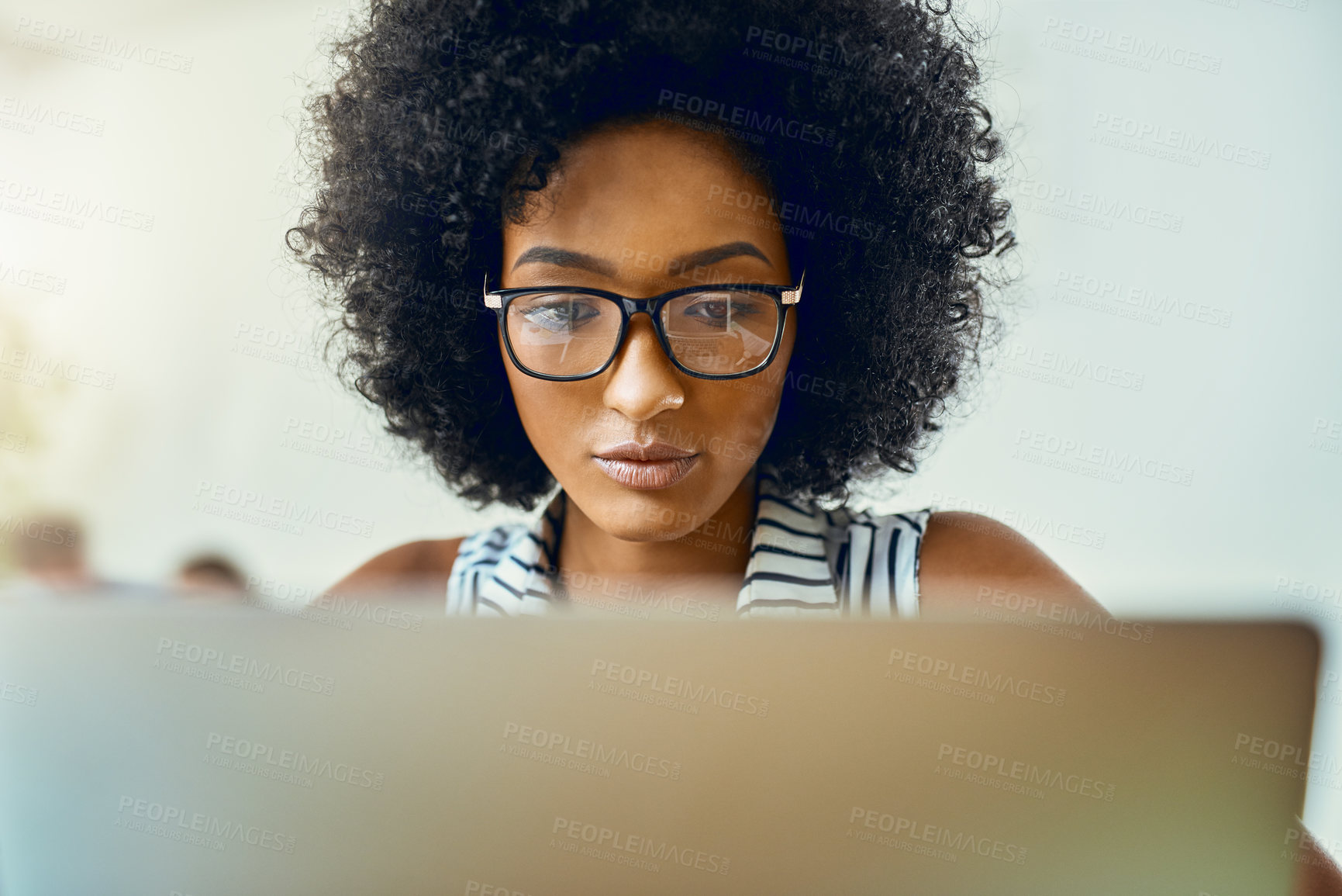 Buy stock photo Black woman, working and laptop in office or company as web designer in digital design agency. Female person, pride and concentration on technology for assignment, project or brief in creative career