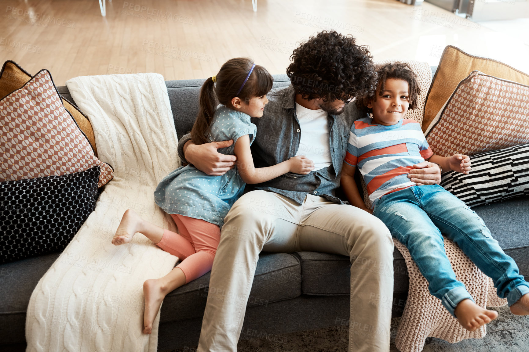 Buy stock photo Family, man and kids with hug on sofa for care, appreciation and bonding together in living room. Love, smile and dad with embrace of children at home for gratitude, trust and support in childhood