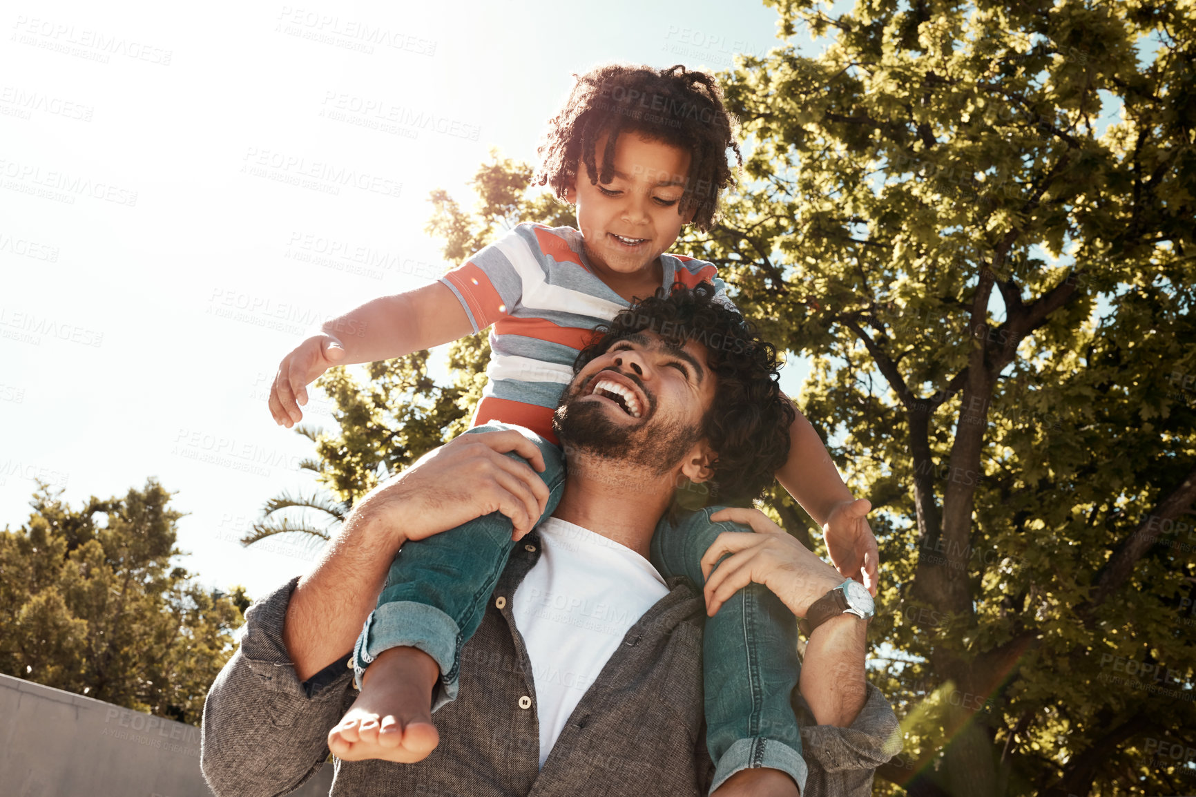 Buy stock photo Happy dad, son and love with piggyback at backyard on holiday, freedom or bonding together at home. Father with young child, kid or little boy on shoulder for fun flying or enjoying weekend in nature