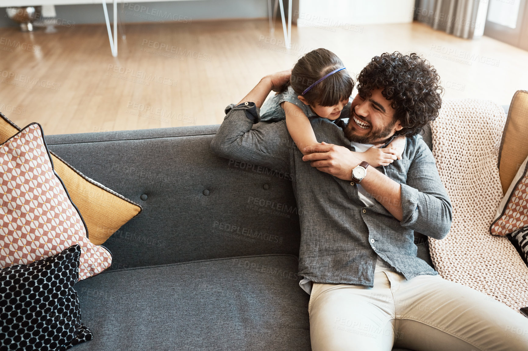 Buy stock photo Family, dad and girl with hug on sofa for appreciation, gratitude and bonding together on weekend. Smile, happy and man with embrace of daughter at home for support, trust and parenting in childhood