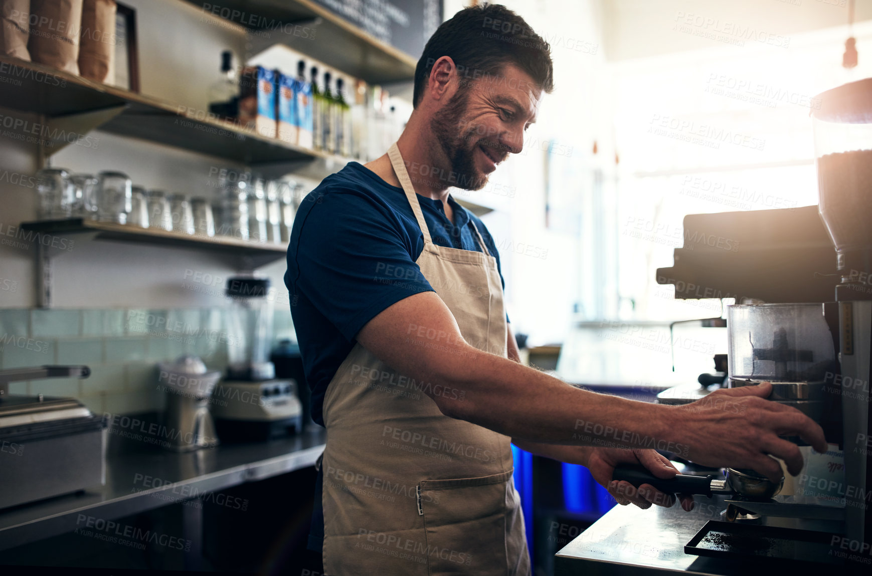 Buy stock photo Shot of a barista operating a coffee machine in a cafe