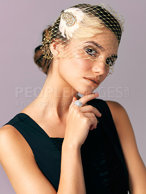 Buy stock photo Studio shot of an elegantly dressed young woman posing against a purple background